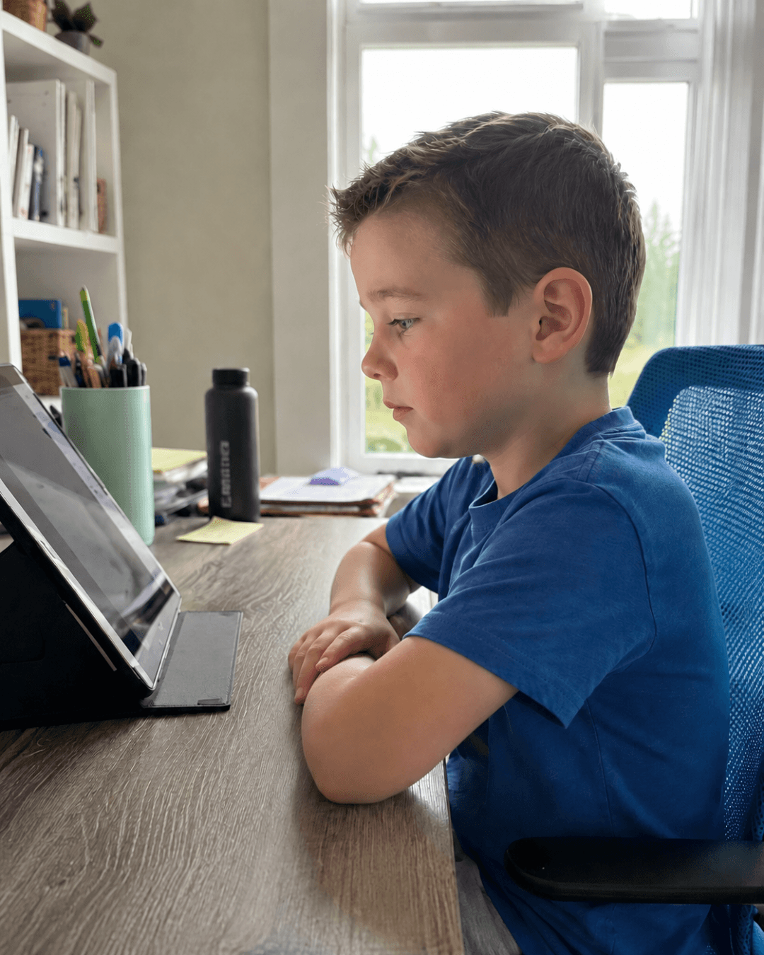Boy joining a live after-school class from home