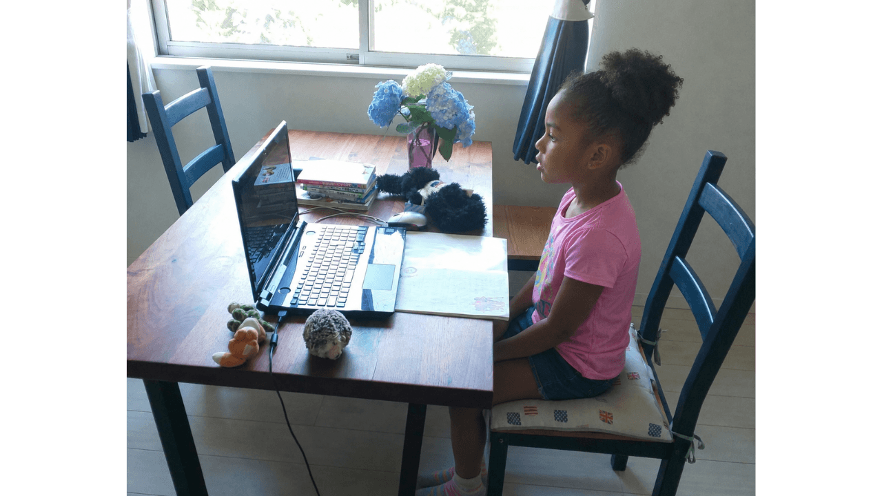 Child smiling while joining a live class from home